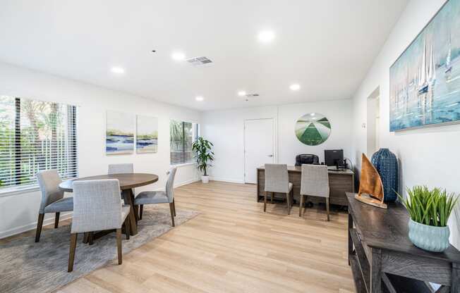 a living room with a dining room table and chairs