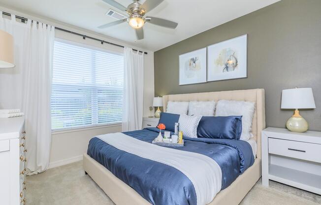 a bedroom with a bed and desk in a room