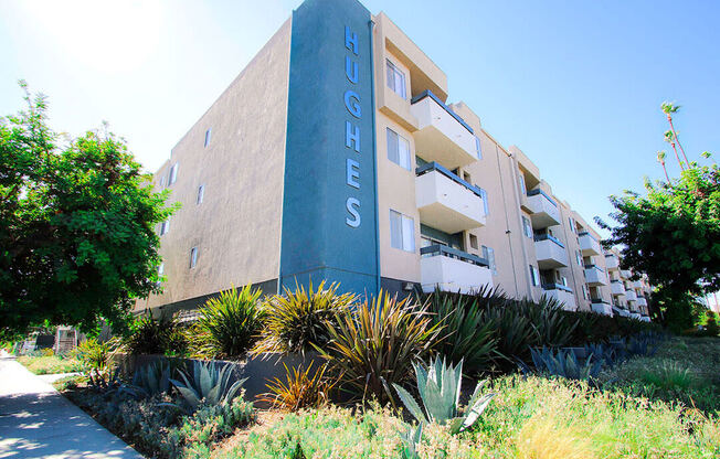 Exterior front of building showing landscaping and freshly painted building colors.