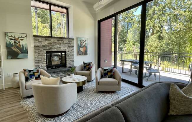 a living room with couches chairs and a fireplace at Commons on the Tualatin River, Tualatin, Oregon