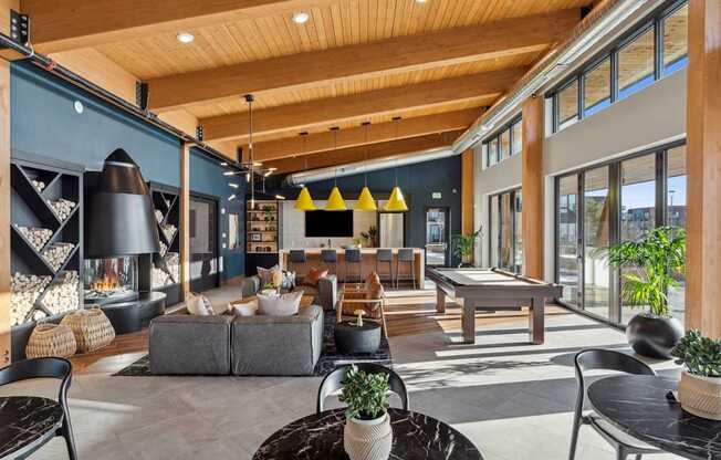 A modern living room with a grey sofa and a black coffee table.