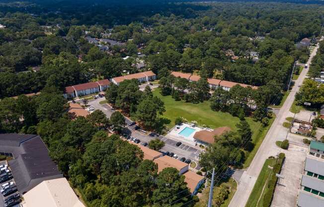 A bird's eye view of a residential area with a swimming pool.
