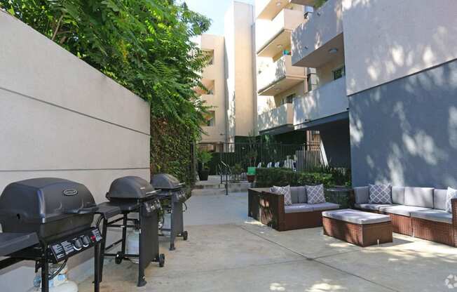 Courtyard view of community seating area next to barbecues.