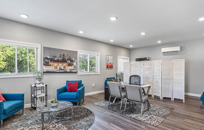 a living room and dining room with a table and chairs