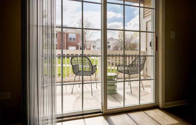 A patio with a table and chairs is visible through a sliding glass door.