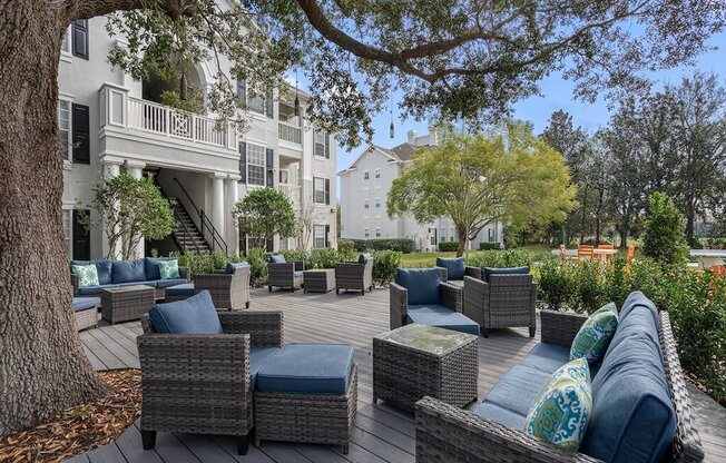 Quiet patio with seating under the shade of a large oak tree