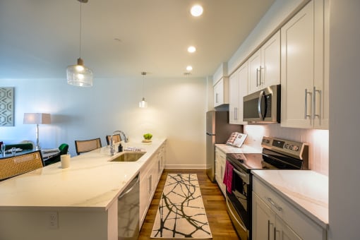 a kitchen with white cabinets and a white counter top