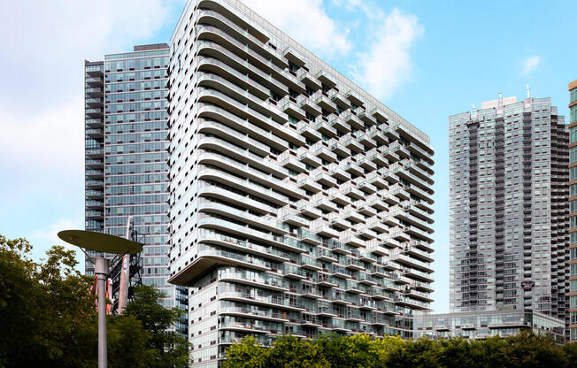 4610 Center Blvd Exterior featuring large balconies, pepsi cola sign, and large parks. 