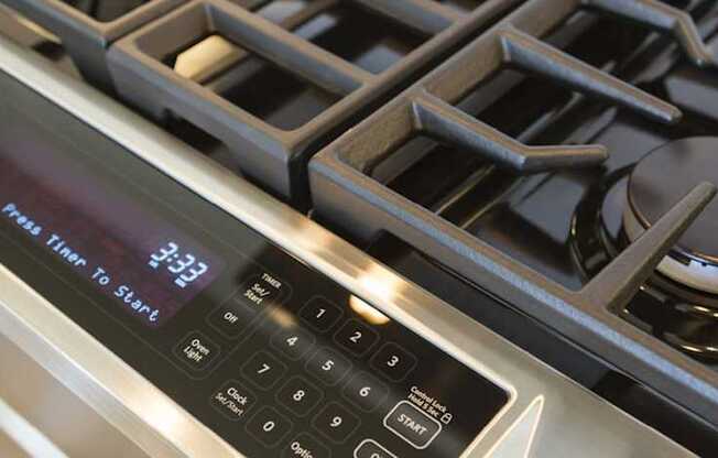 A digital display on a stove shows the time as 3:33.