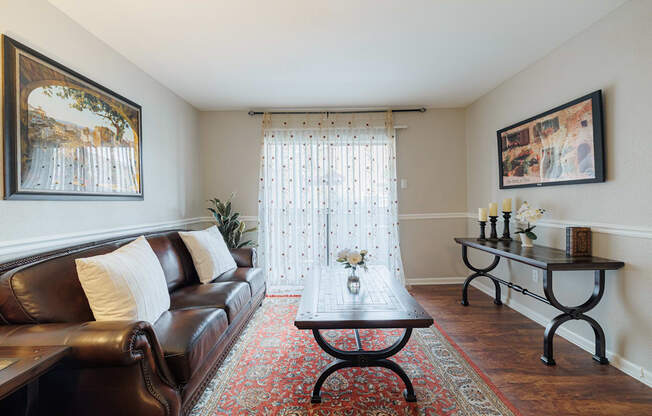 a living room with a leather couch and a coffee table