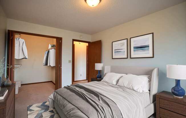 a bedroom with a bed and two night stands. Fargo, ND Westwood Estates Apartments