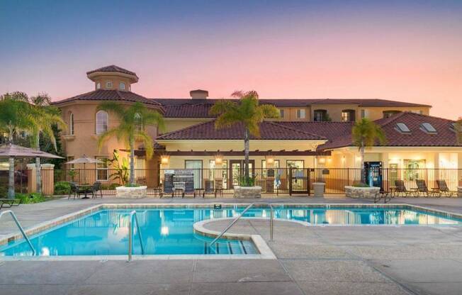 A large house with a pool in front of it.