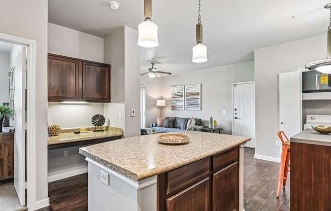 A kitchen with a countertop and a ceiling fan.