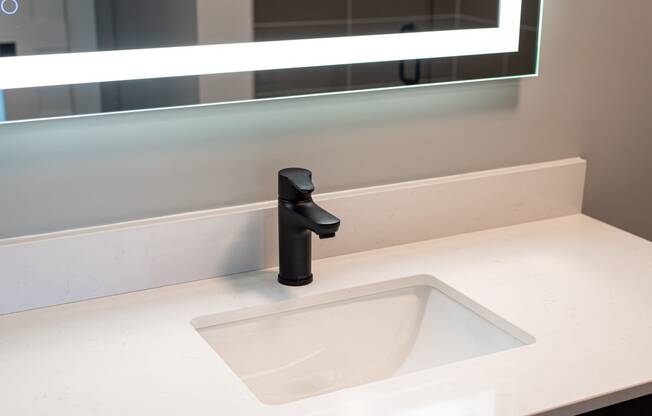 a sink in a bathroom with a black faucet