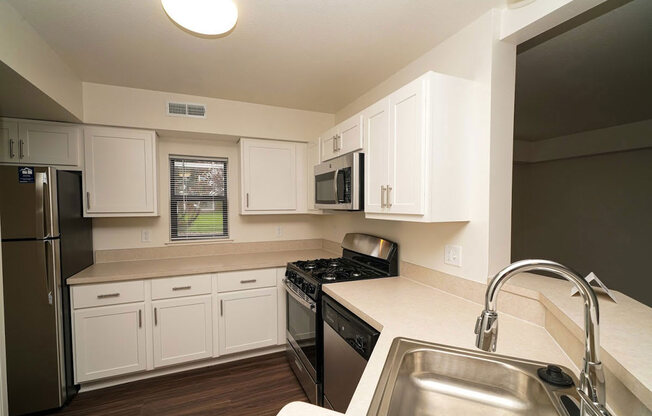 a renovated end style kitchen with a window