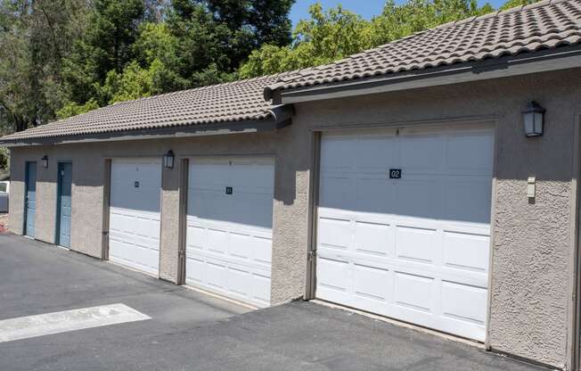 a row of garages with white garage doors