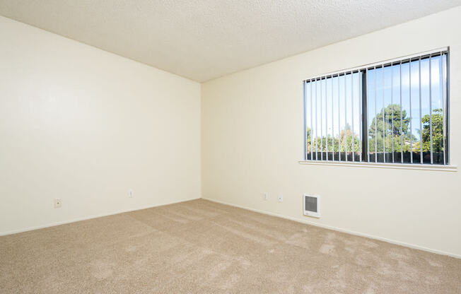 an empty living room with a large window