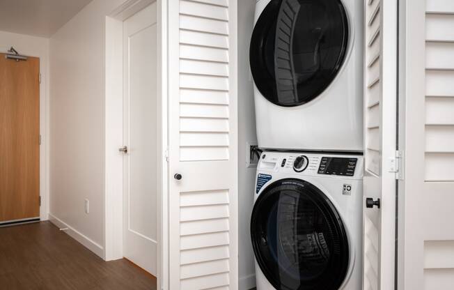 a washer and dryer in a laundry room with a white closet at Slabtown Square Apartments, Portland , OR 97209
