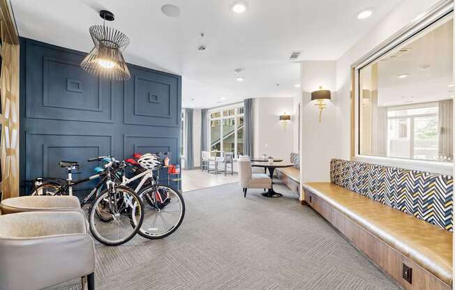 A room with a bicycle and a bench.