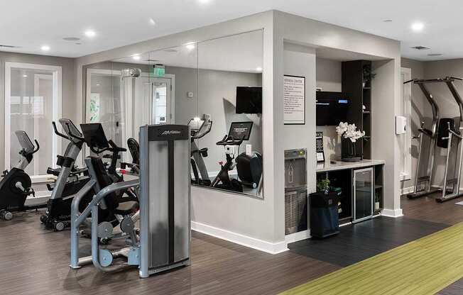 a gym with cardio equipment and weights in a building