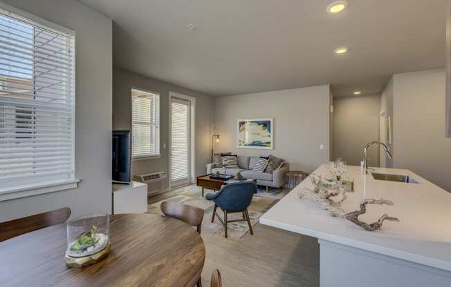 a kitchen and living room with a table and chairs