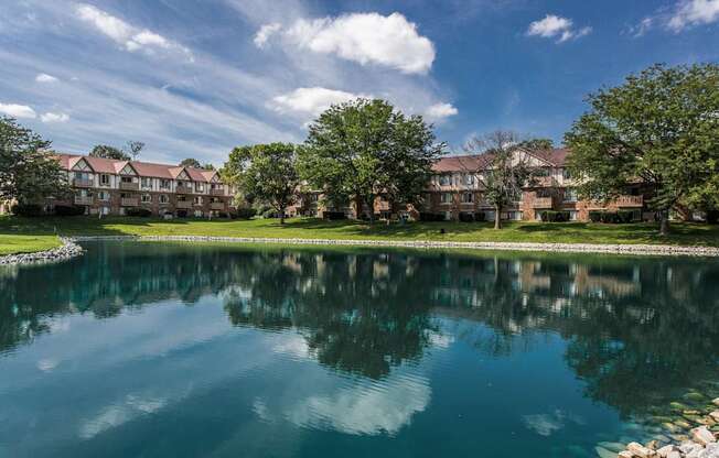 A serene lake in front of a residential area.