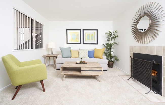 Apartment Thousand Oaks CA - The Knolls - Living Area with Green Chair, Carpeting, and Fireplace