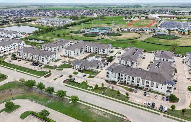 an aerial view of a community with houses and a parking lot