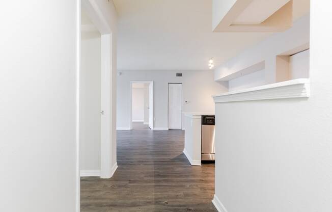 a living room with white walls and a wooden floor at Heritage Bay, Jensen Beach, 34957