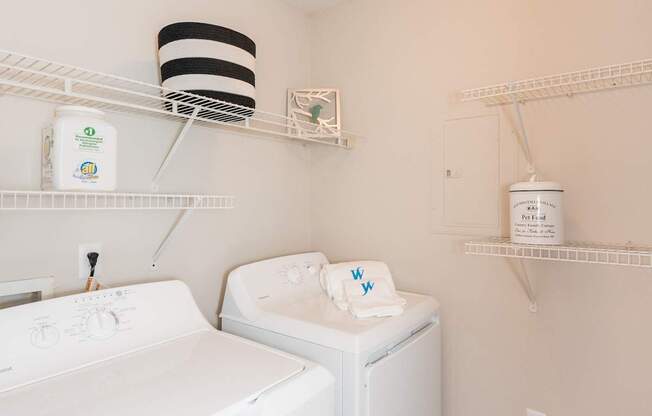 A white washing machine and dryer in a small laundry room.