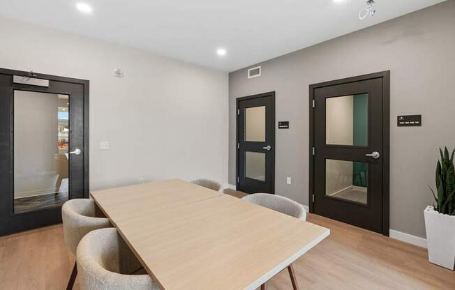 A conference room with a long table and chairs.