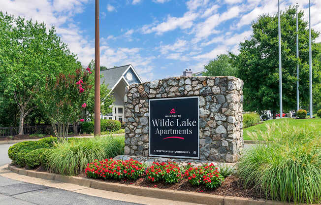 the sign at the entrance of white lake apartments