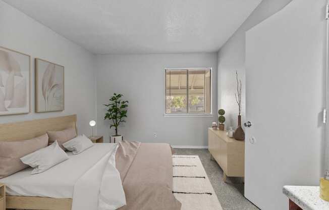 a bedroom with a bed and a dresser and a window