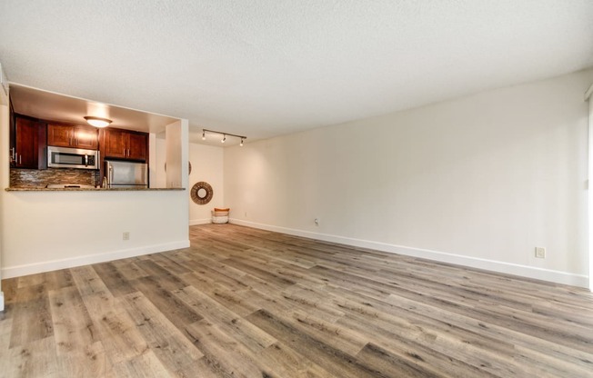 Vacant apartment home located on the first floor with hardwood inspired flooring through out with views of the open concept kitchen and front door. 