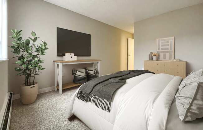 A bedroom with a large bed and a flat screen TV mounted on the wall.