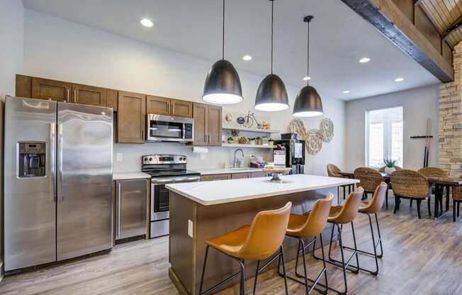 A modern kitchen with a large island and stainless steel appliances.