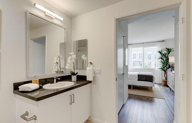 a kitchen with a sink and a mirror