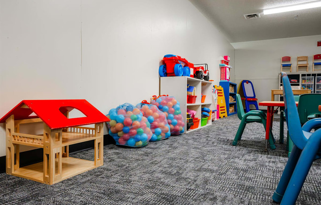 a play room with toys and chairs and a table with chairs at Sutton Hill Apartments, Des Moines, 50320