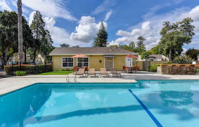 Community pool area with blue skies and clear water. 