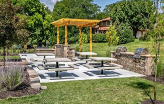 a picnic area in a park with benches and a pavilion