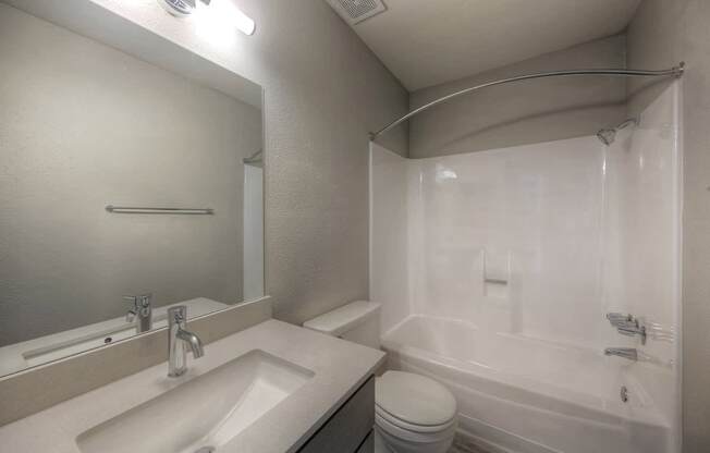 A white sink and toilet in a small bathroom.