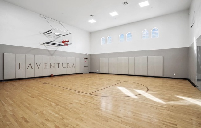 the gym has a hardwood floor and a basketball court
