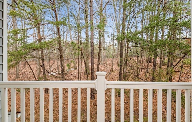 a white fence in front of a wooded area at ReNew Odenton, Maryland, 21113