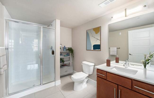 A bathroom with a toilet, sink, and shower.