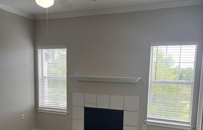 a bathroom with a tv on the wall and a window