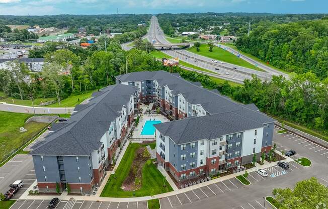A large apartment complex with a swimming pool in the middle.