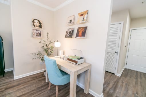 a bedroom with a desk and a chair and a door