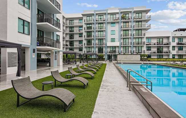 Poolside loungers in our resort-style pool area at Twenty2 West luxury apartments in Miami, FL