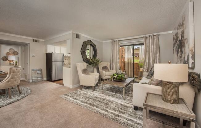 a living room with white furniture and a rug at Lodge of Overland Park Apartments, Overland Park , KS