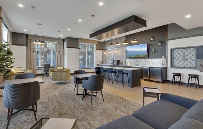 A modern living room with a grey sofa and a bar area.